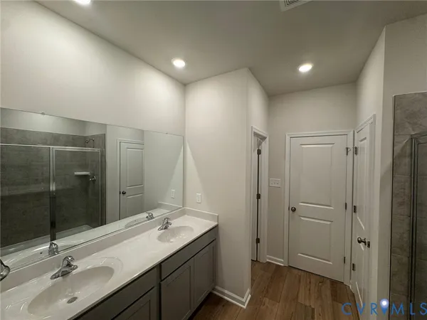 a bathroom with a double vanity sink and mirror
