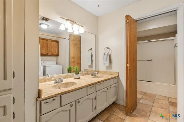 a bathroom with a double vanity sink mirror and double