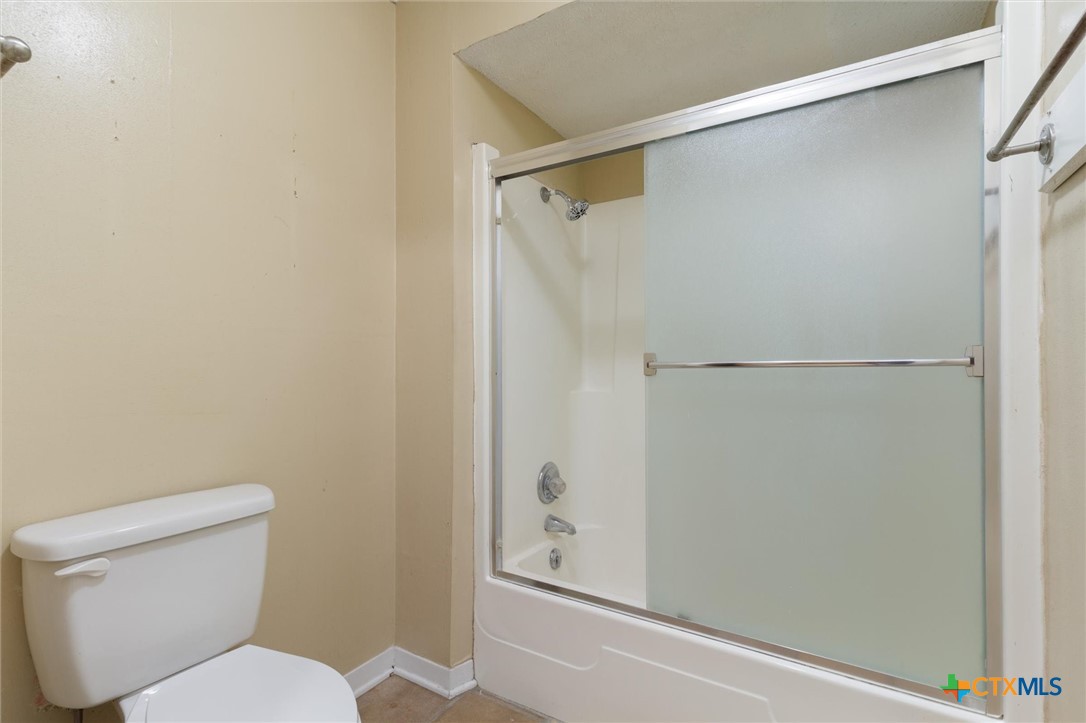 821 Ranch Road 12 San Marcos, TX 78666 - Photo 16 of 30 a white toilet sitting next to a shower