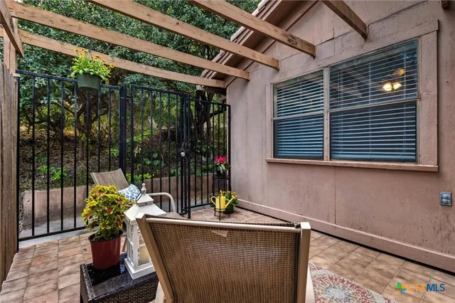 a view of a chairs and table in the backyard