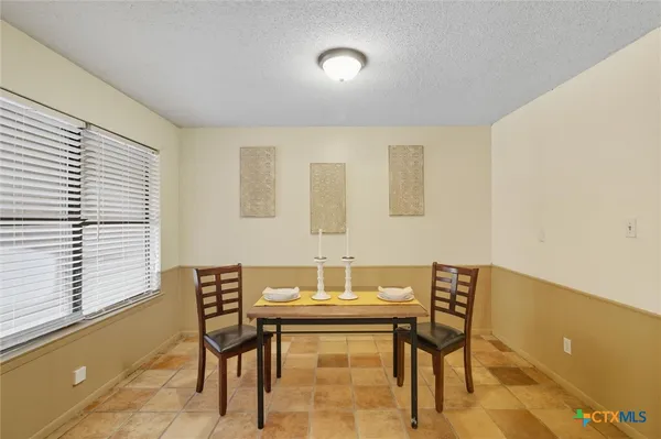 a dining room with furniture and window