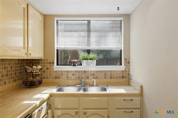 a bathroom with a sink and a window