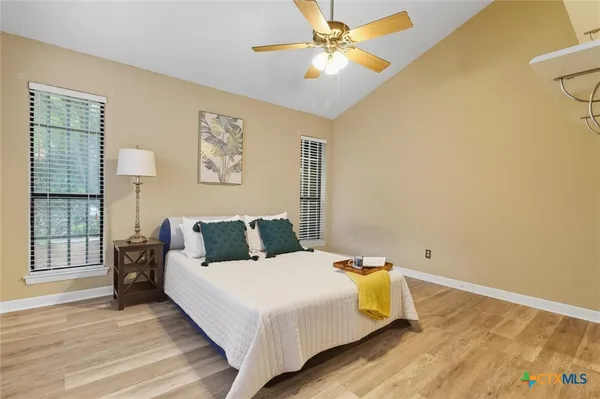 a bedroom with a bed and wooden floor
