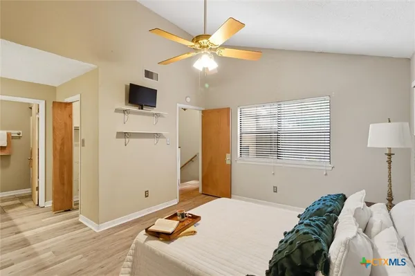 a bedroom with a bed and a chandelier