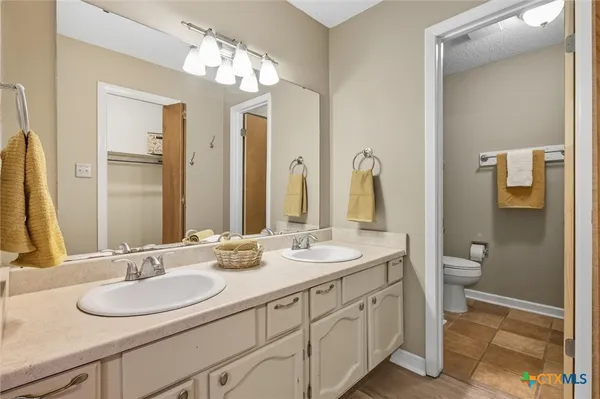a bathroom with a double vanity sink and a mirror
