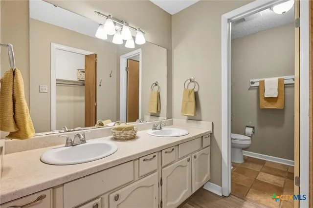 a bathroom with a double vanity sink and a mirror