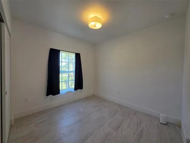 an empty room with window and windows