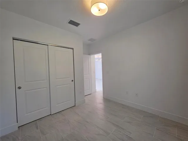an empty room with closet area