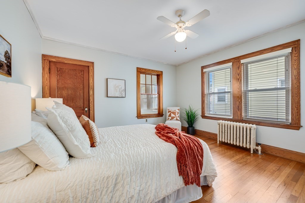 44 Jasper Street Saugus, MA 01906 - Photo 17 of 32 a bed room with a bed and a chandelier