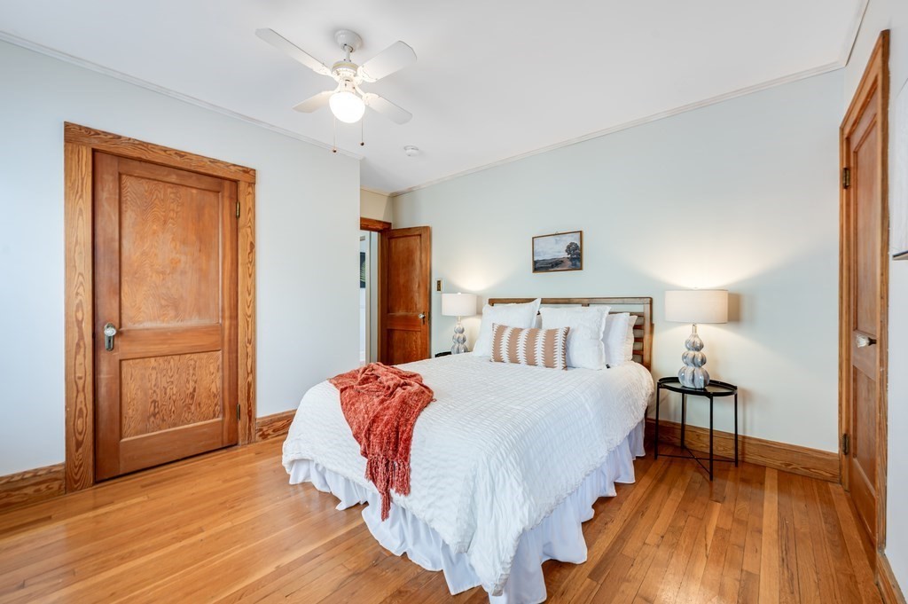 44 Jasper Street Saugus, MA 01906 - Photo 18 of 32 a spacious bedroom with a bed and a chandelier