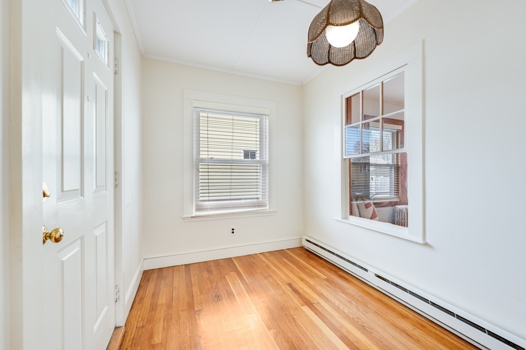 44 Jasper Street Saugus, MA 01906 - Photo 3 of 32 a view of an empty room with wooden floor and a window
