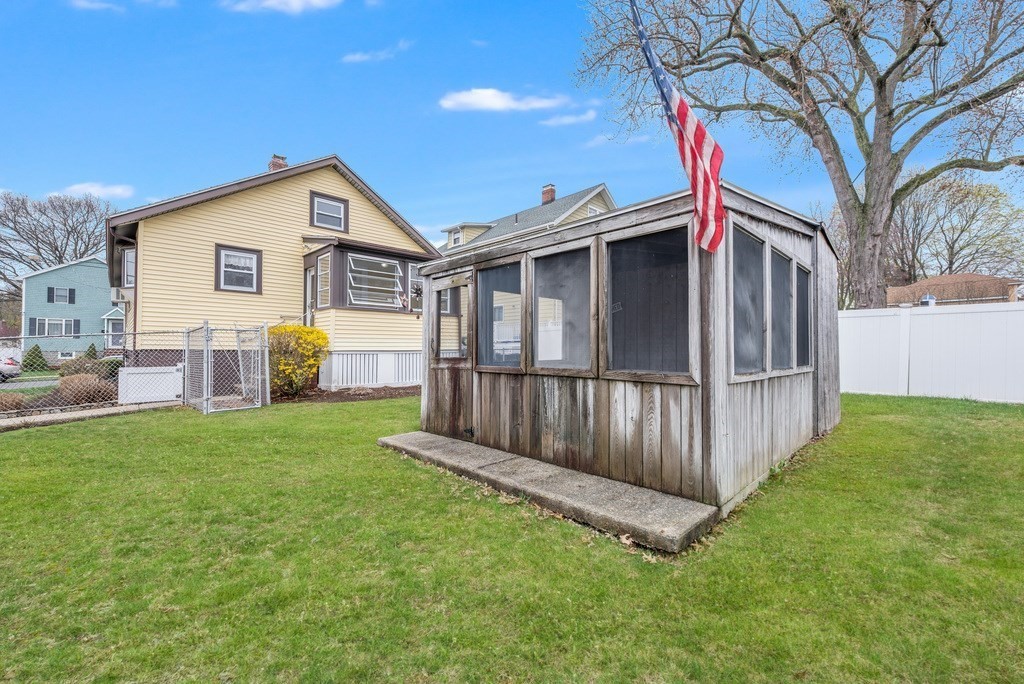 44 Jasper Street Saugus, MA 01906 - Photo 31 of 32 a view of a house with a yard and wooden fence