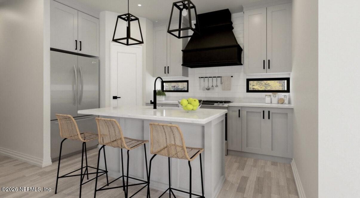 a kitchen with stainless steel appliances kitchen island a refrigerator sink and microwave