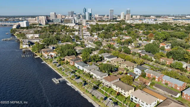 a view of swimming pool with outdoor seating and trees in the background