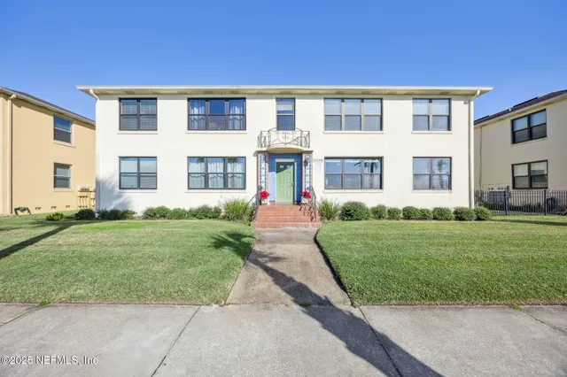 a living room with furniture a flat screen tv and a book shelf