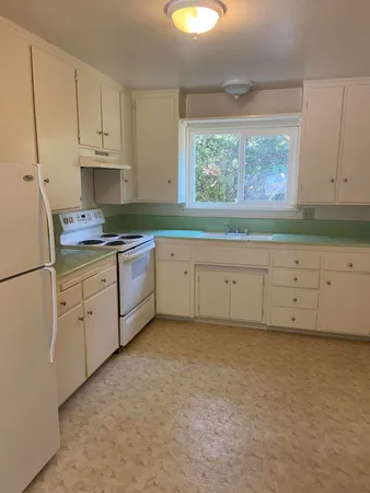 a view of a kitchen with electric appliances