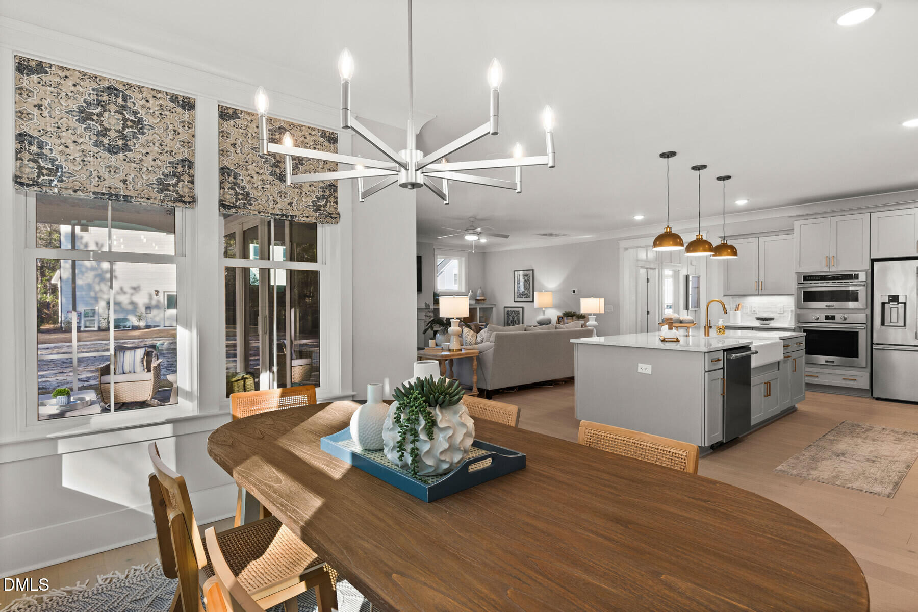 8116 Andrea Lane, Unit 101 Raleigh, NC 27613 - Photo 8 of 17 a room with stainless steel appliances kitchen island granite countertop furniture wooden floor and a large window