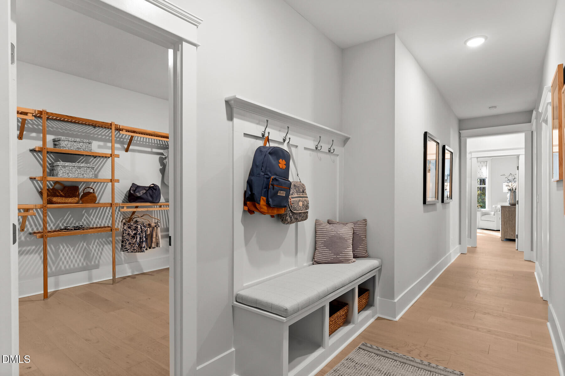 8116 Andrea Lane, Unit 101 Raleigh, NC 27613 - Photo 9 of 17 a hallway with white cabinets and wooden floor