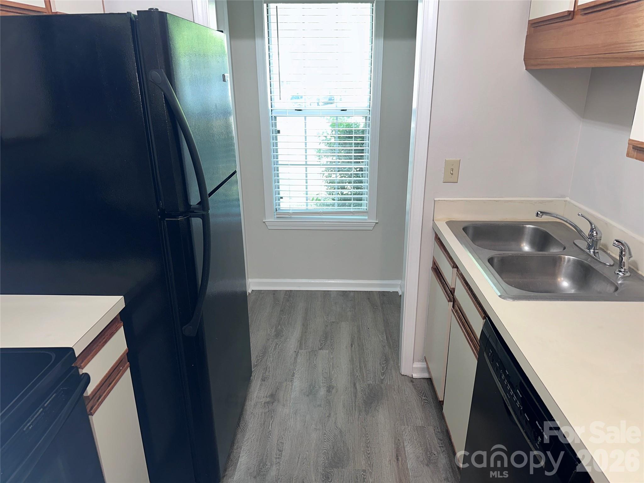 6725 Bevington Ridge Road, Unit A/B Charlotte, NC 28277 - Photo 11 of 48 a kitchen with a sink a refrigerator and wooden floor
