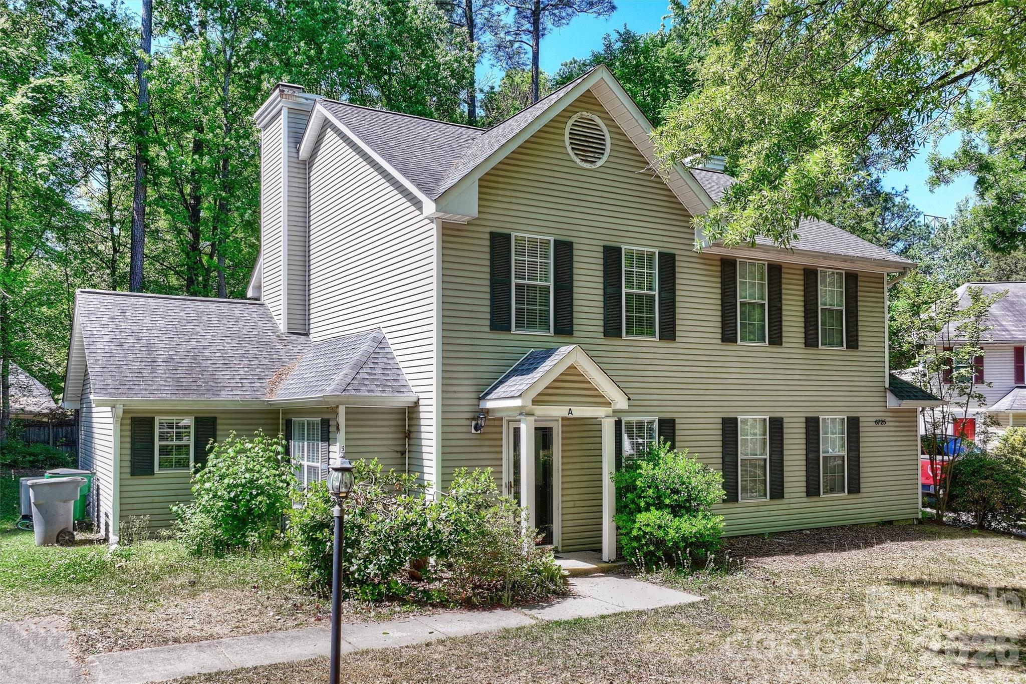 6725 Bevington Ridge Road, Unit A/B Charlotte, NC 28277 - Photo 2 of 48 a front view of a house with garden