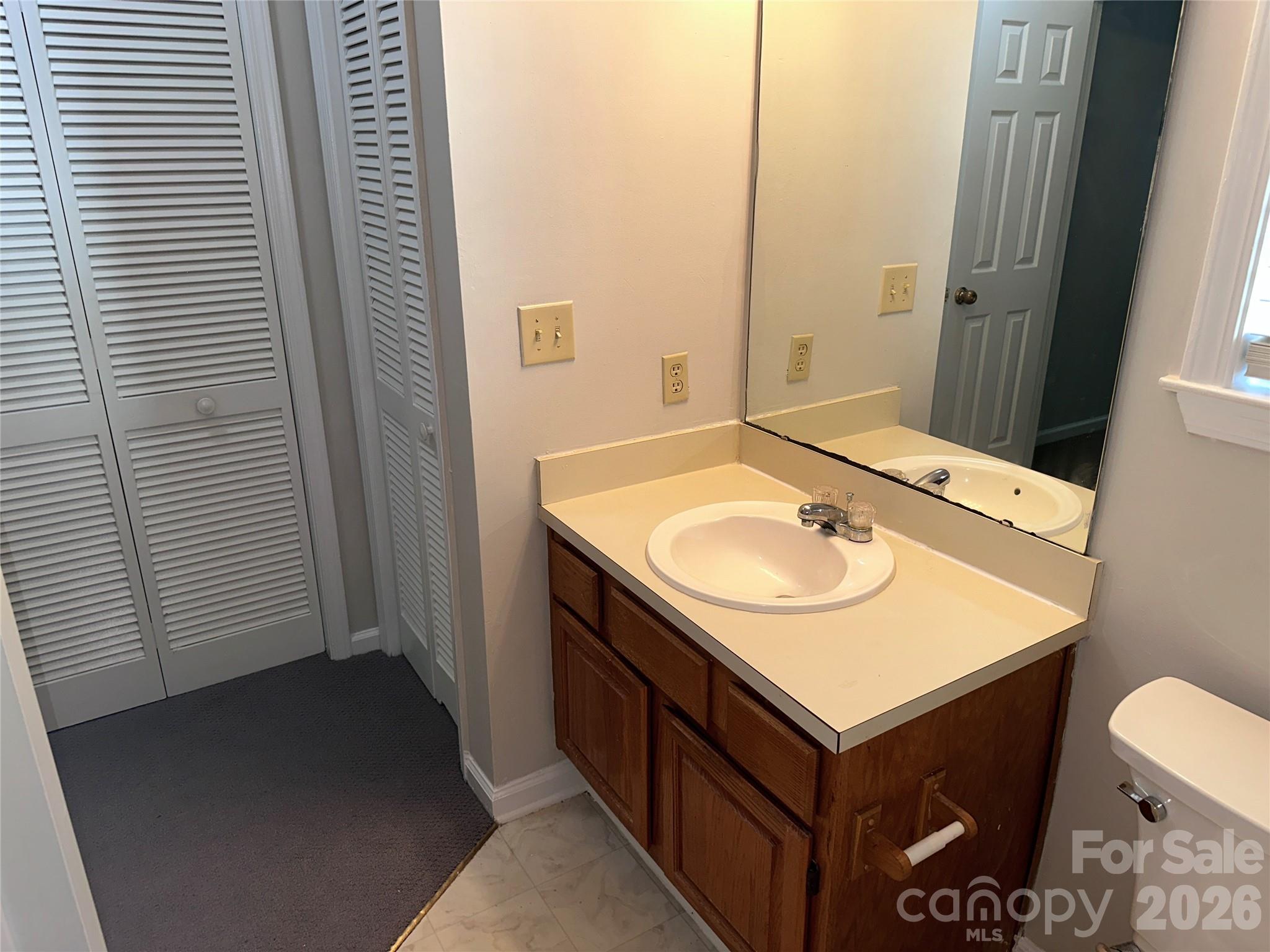 6725 Bevington Ridge Road, Unit A/B Charlotte, NC 28277 - Photo 21 of 48 a bathroom with a sink and a mirror