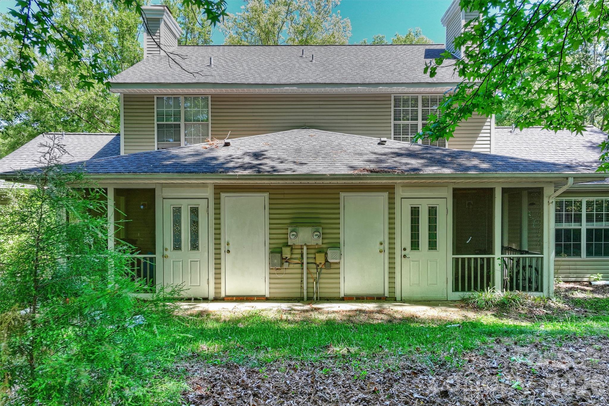 6725 Bevington Ridge Road, Unit A/B Charlotte, NC 28277 - Photo 3 of 48 a front view of a house with a garden and plants