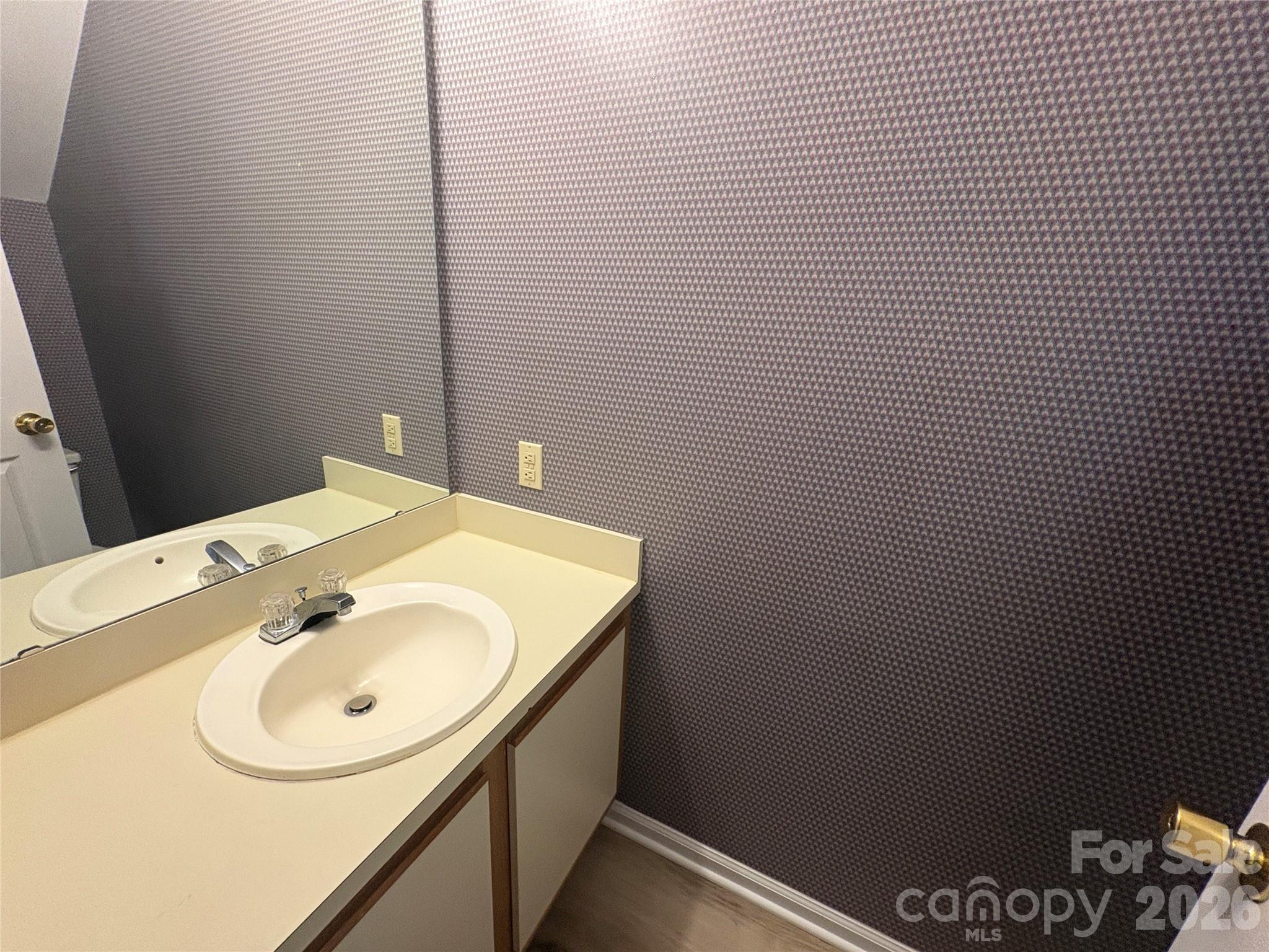 6725 Bevington Ridge Road, Unit A/B Charlotte, NC 28277 - Photo 31 of 48 a bathroom with a sink and a mirror