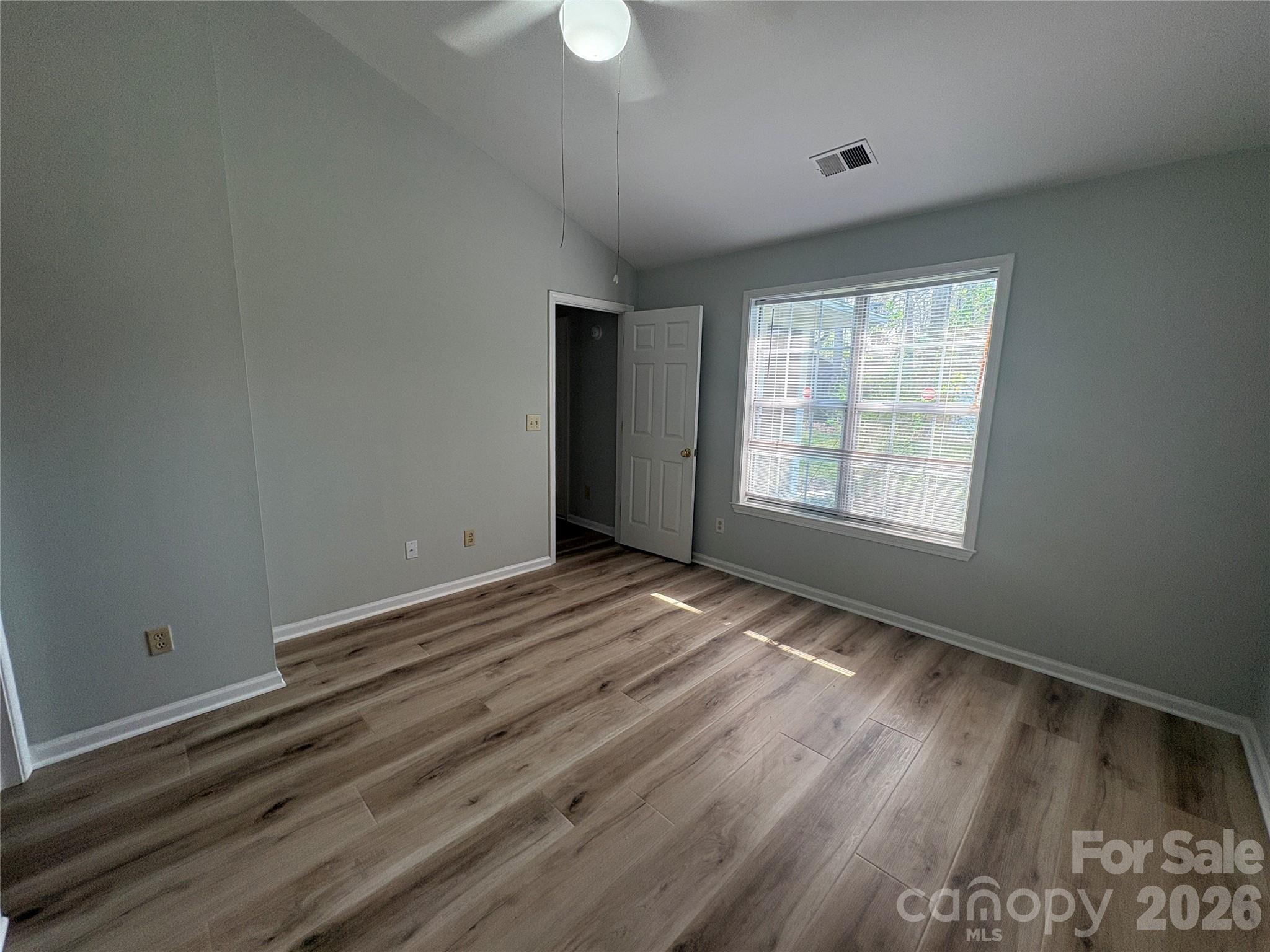 6725 Bevington Ridge Road, Unit A/B Charlotte, NC 28277 - Photo 32 of 48 a view of an empty room with wooden floor and a window