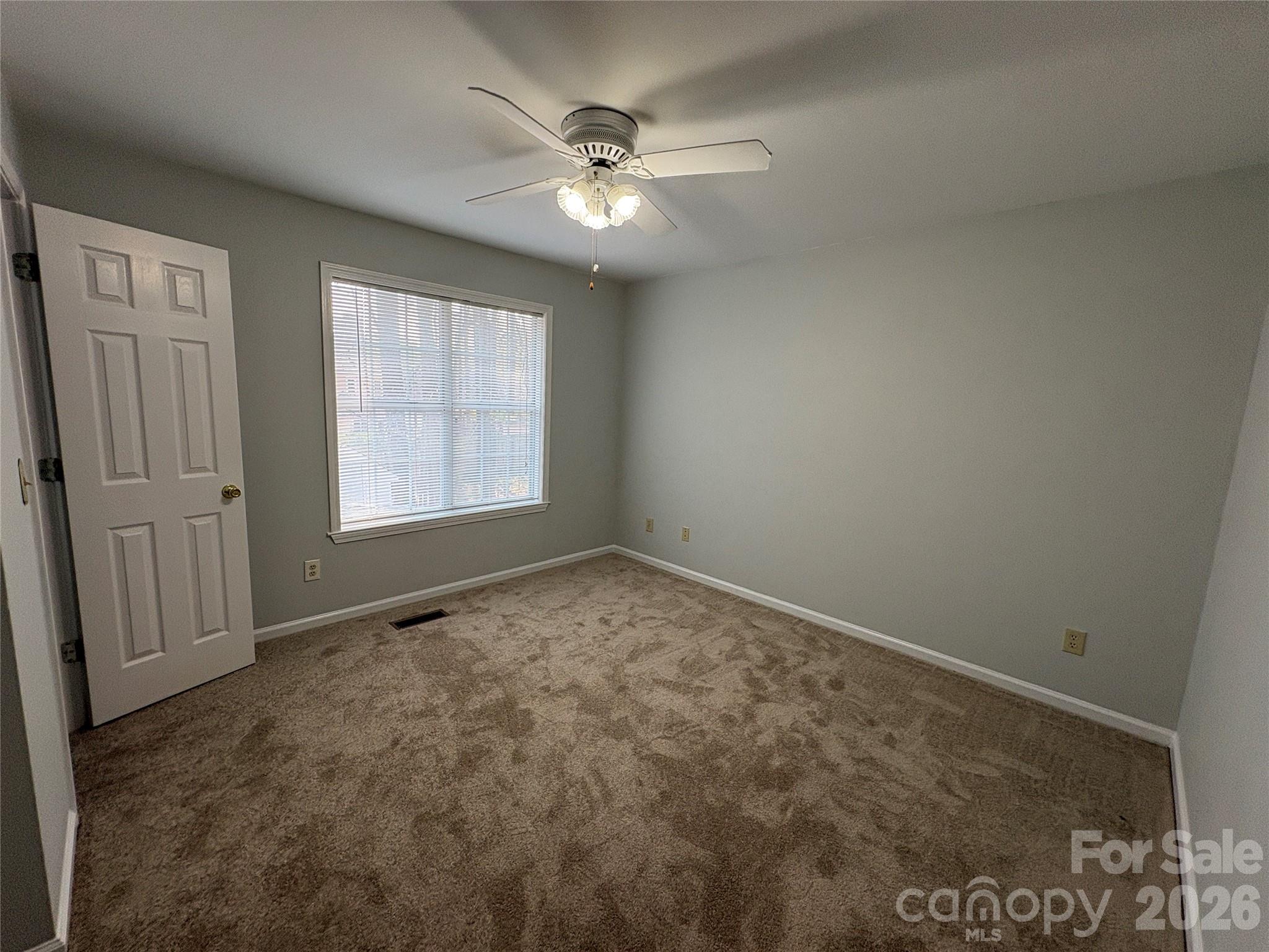 6725 Bevington Ridge Road, Unit A/B Charlotte, NC 28277 - Photo 39 of 48 an empty room with windows and fan