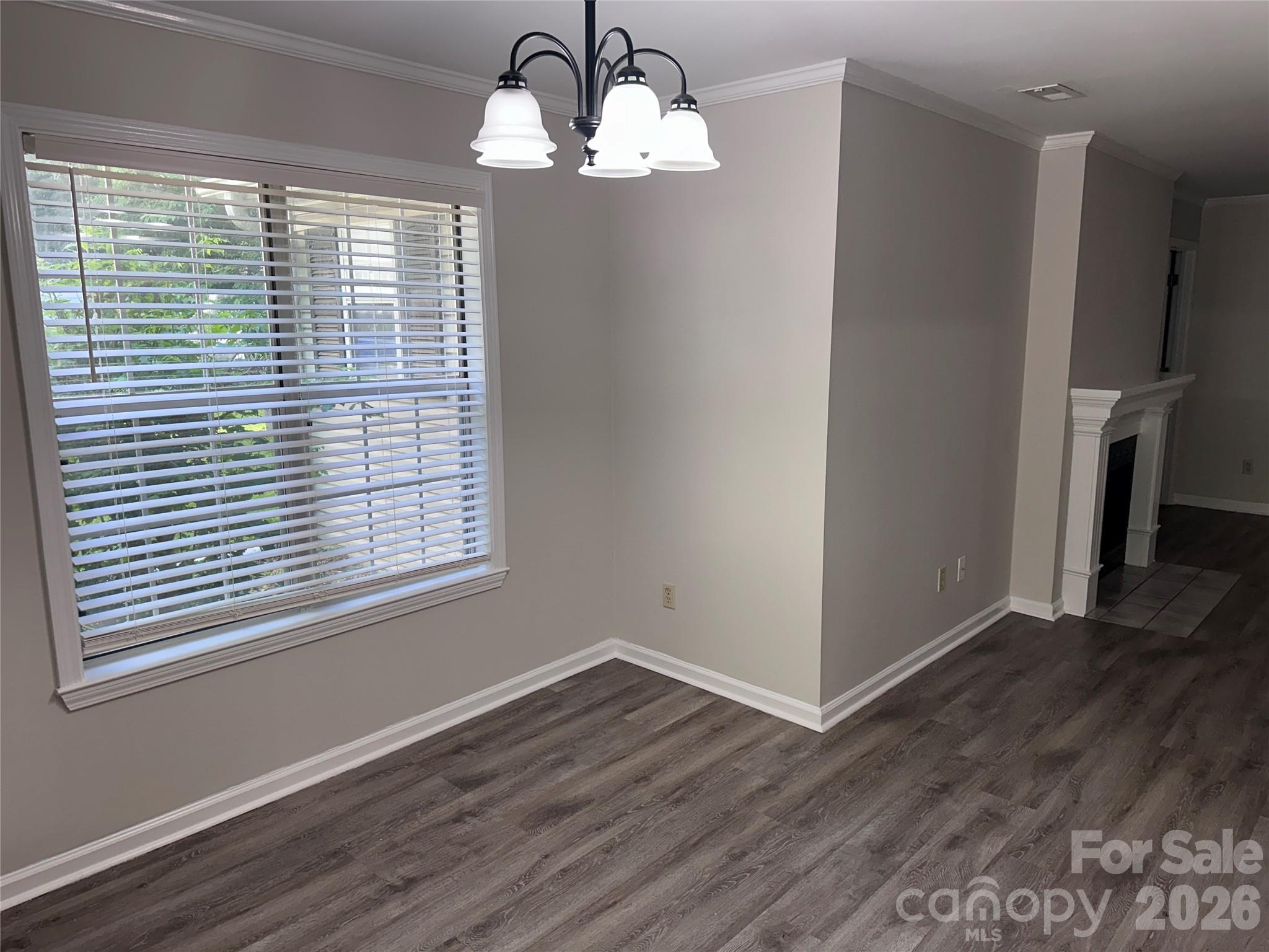 6725 Bevington Ridge Road, Unit A/B Charlotte, NC 28277 - Photo 6 of 48 a view of a livingroom with a large window wooden floor and chandelier