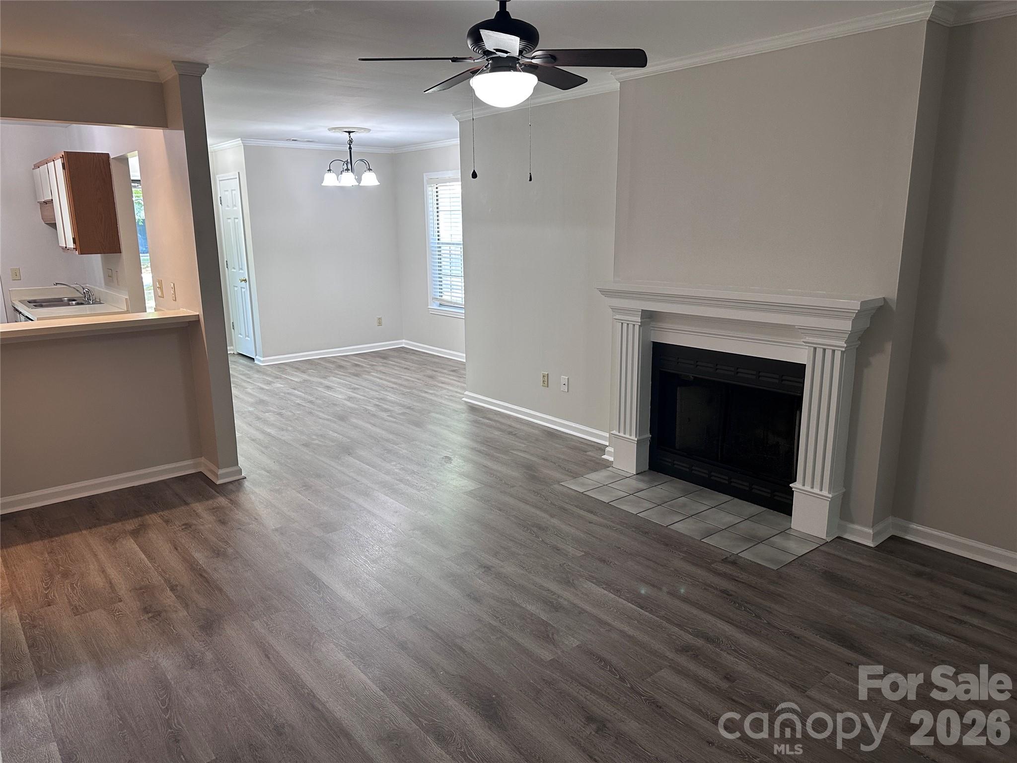 6725 Bevington Ridge Road, Unit A/B Charlotte, NC 28277 - Photo 7 of 48 a view of an empty room with wooden floor and a fireplace