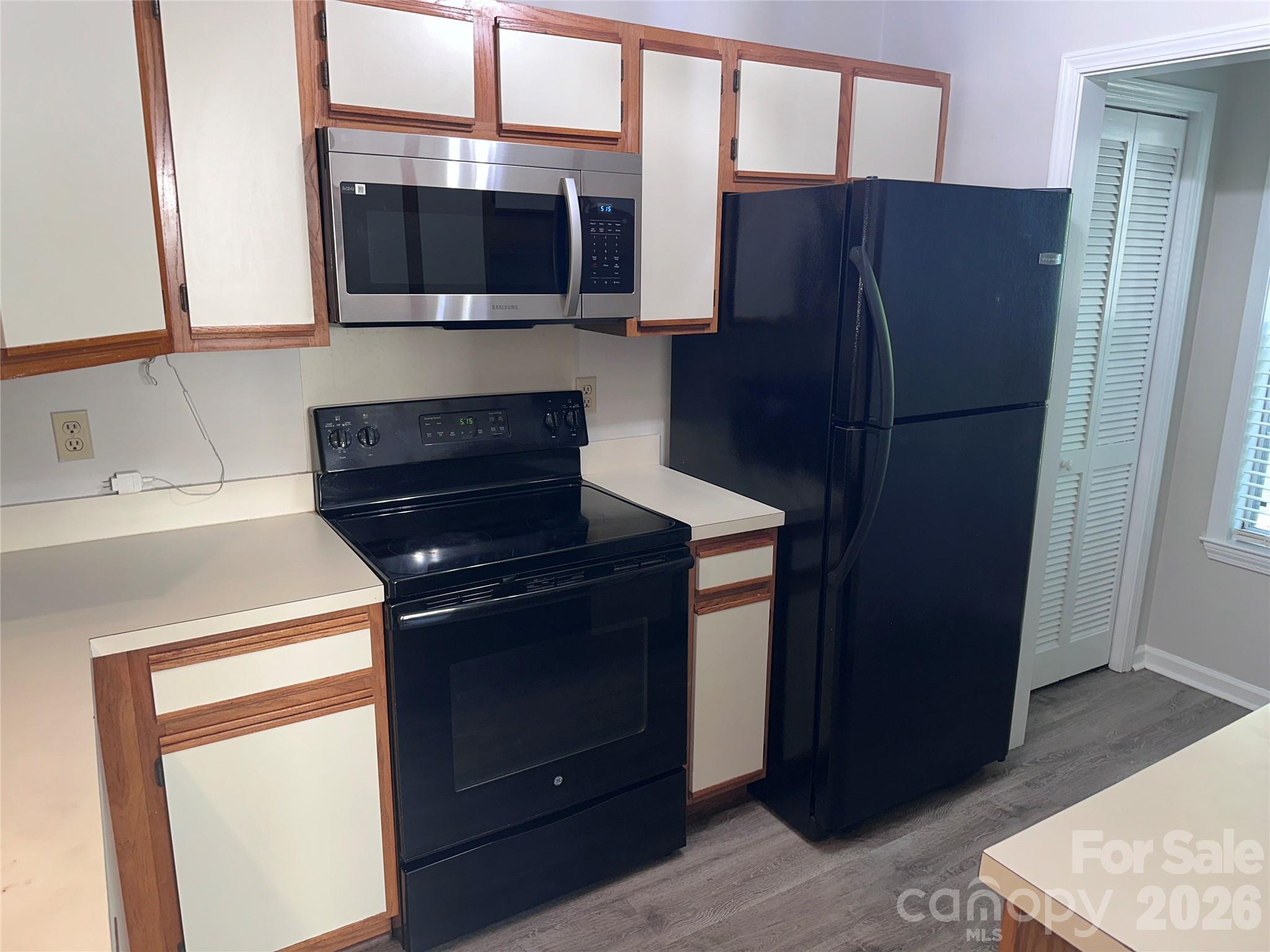 6725 Bevington Ridge Road, Unit A/B Charlotte, NC 28277 - Photo 9 of 48 a kitchen with stainless steel appliances granite countertop a refrigerator and a microwave