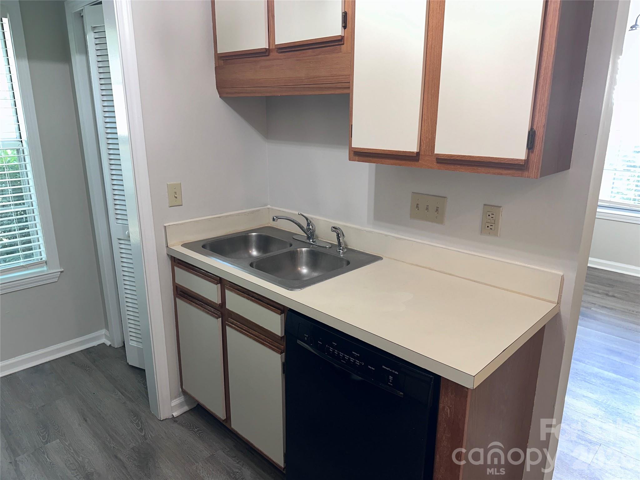 6725 Bevington Ridge Road, Unit A/B Charlotte, NC 28277 - Photo 10 of 48 a kitchen with a sink cabinets and wooden floor