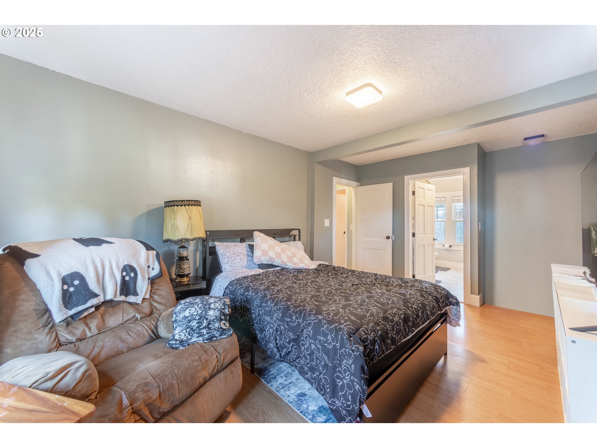 745 16th Street Northeast Salem, OR 97301 - Photo 12 of 32 a bedroom with a bed and a night stand