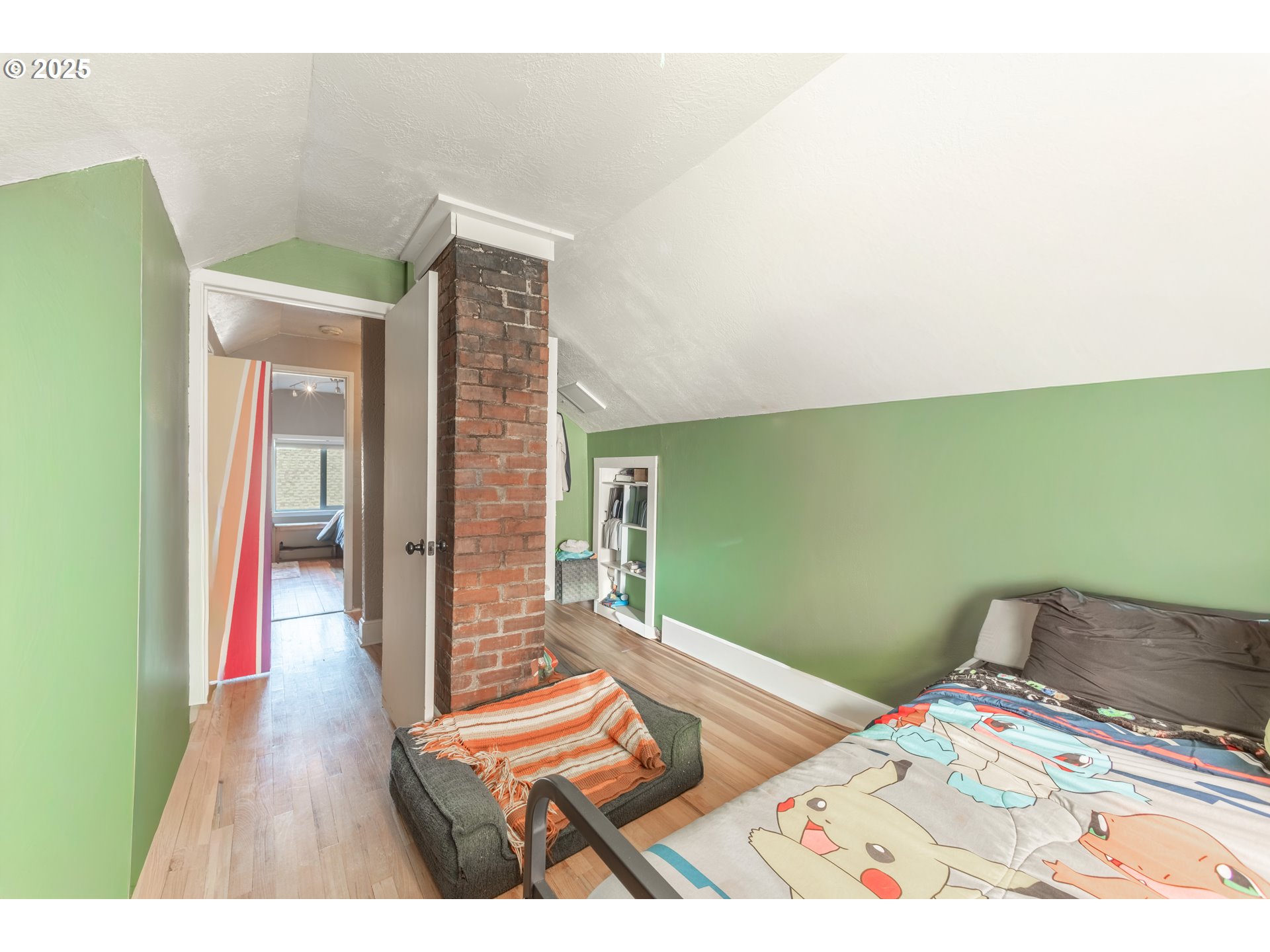 745 16th Street Northeast Salem, OR 97301 - Photo 19 of 32 a bedroom with a bed and a bookshelf