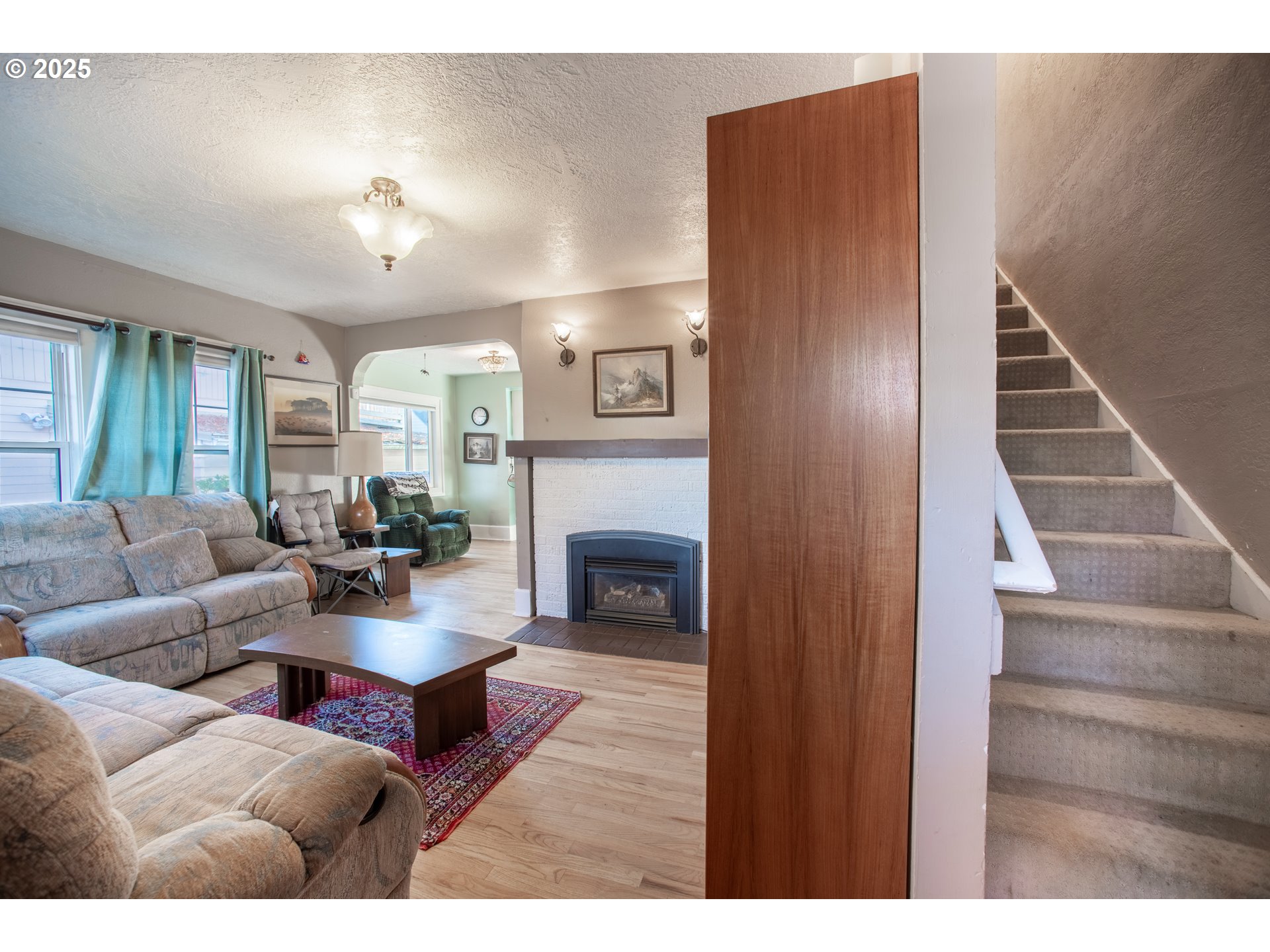 745 16th Street Northeast Salem, OR 97301 - Photo 2 of 32 a living room with furniture and a fireplace