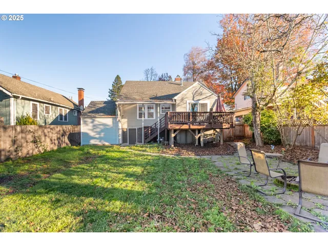 a view of a house with a big yard and potted plants