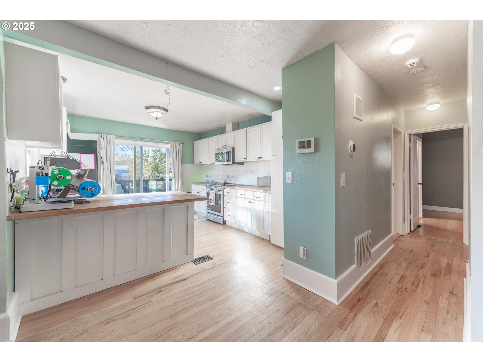 745 16th Street Northeast Salem, OR 97301 - Photo 5 of 32 a open kitchen with cabinets and wooden floors