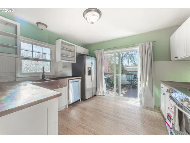 a open kitchen with granite countertop a stove top oven a sink and dishwasher