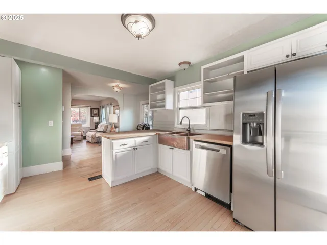 a kitchen with a refrigerator and a sink