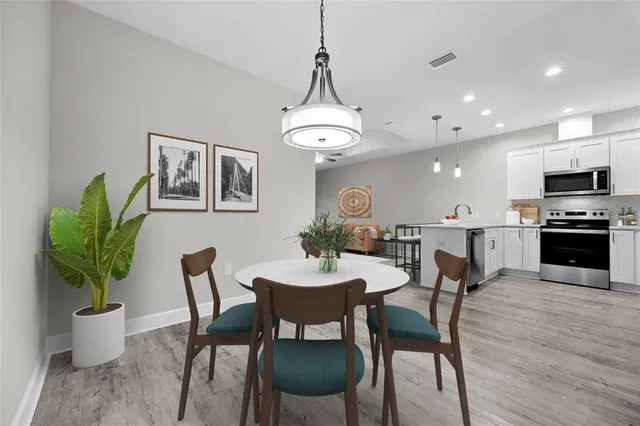 a view of a dining room with furniture and wooden floor