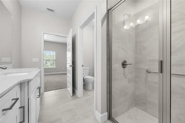 a bathroom with a shower and a sink