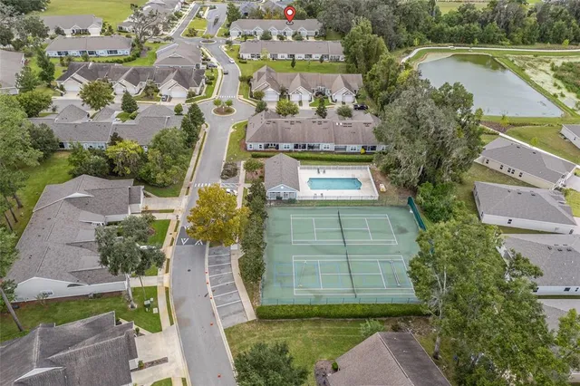 an aerial view of a house with a yard and lake view