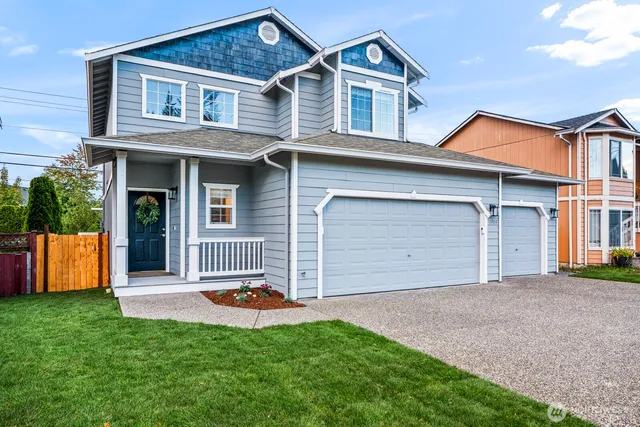 a front view of a house with a yard and garage