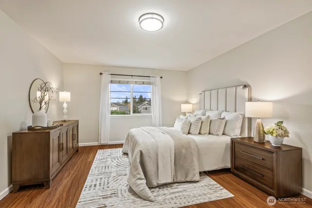 a bedroom with bed and wooden floor
