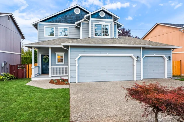 a front view of a house with a yard and garage