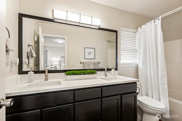 a bathroom with a double vanity sink and a mirror