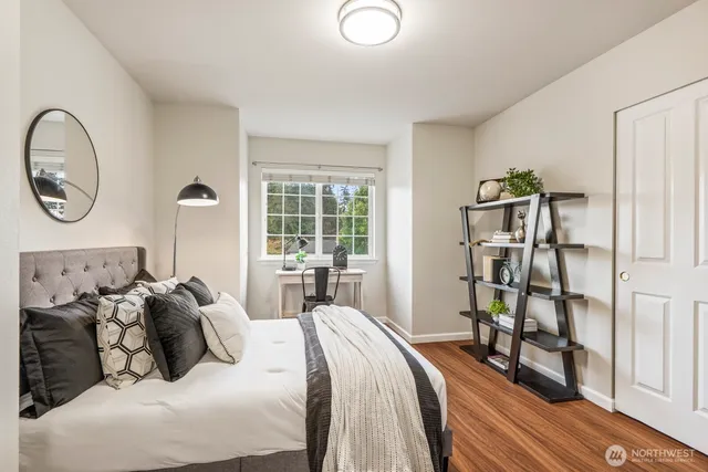 a bedroom with bed and a large mirror