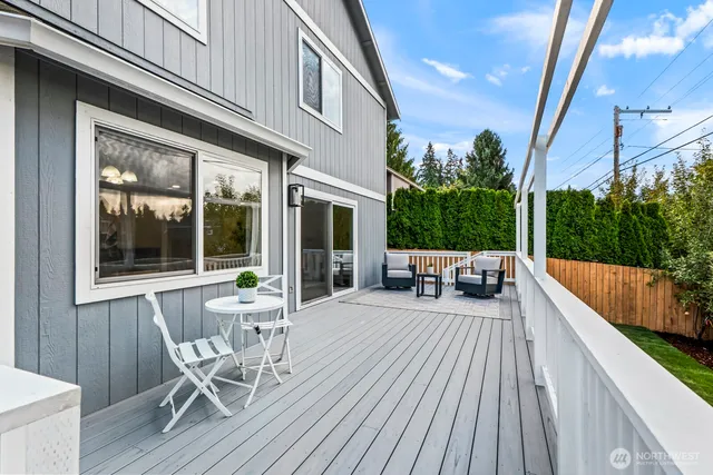 a view of a patio with couches table and chairs and potted plants