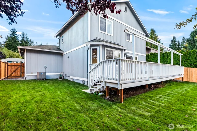 a view of a backyard with a garden and deck